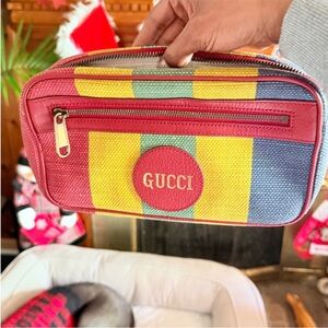Gucci Baiadera striped canvas belt bag with red trim.